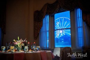 Interior of Candlelight ballroom with view of Ferris wheel at night from window