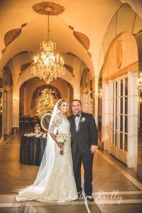 Bride and groom posing in hall of mirrors