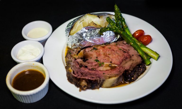 prime rib with au jus and horseradish cream on side.