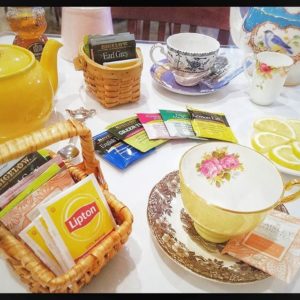 hot tea setup with kettle and china cups