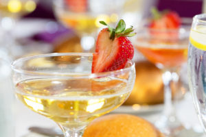 champagne glass filled with strawberry garnish